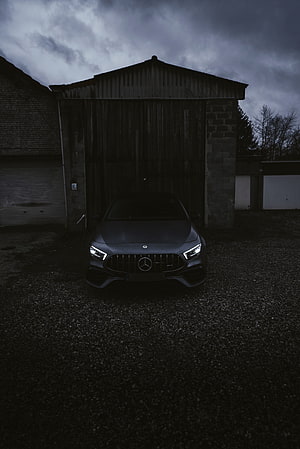 Dark Matte Mercedes-AMG A45 S Front View in Moody Industrial Setting HD phone wallpaper
