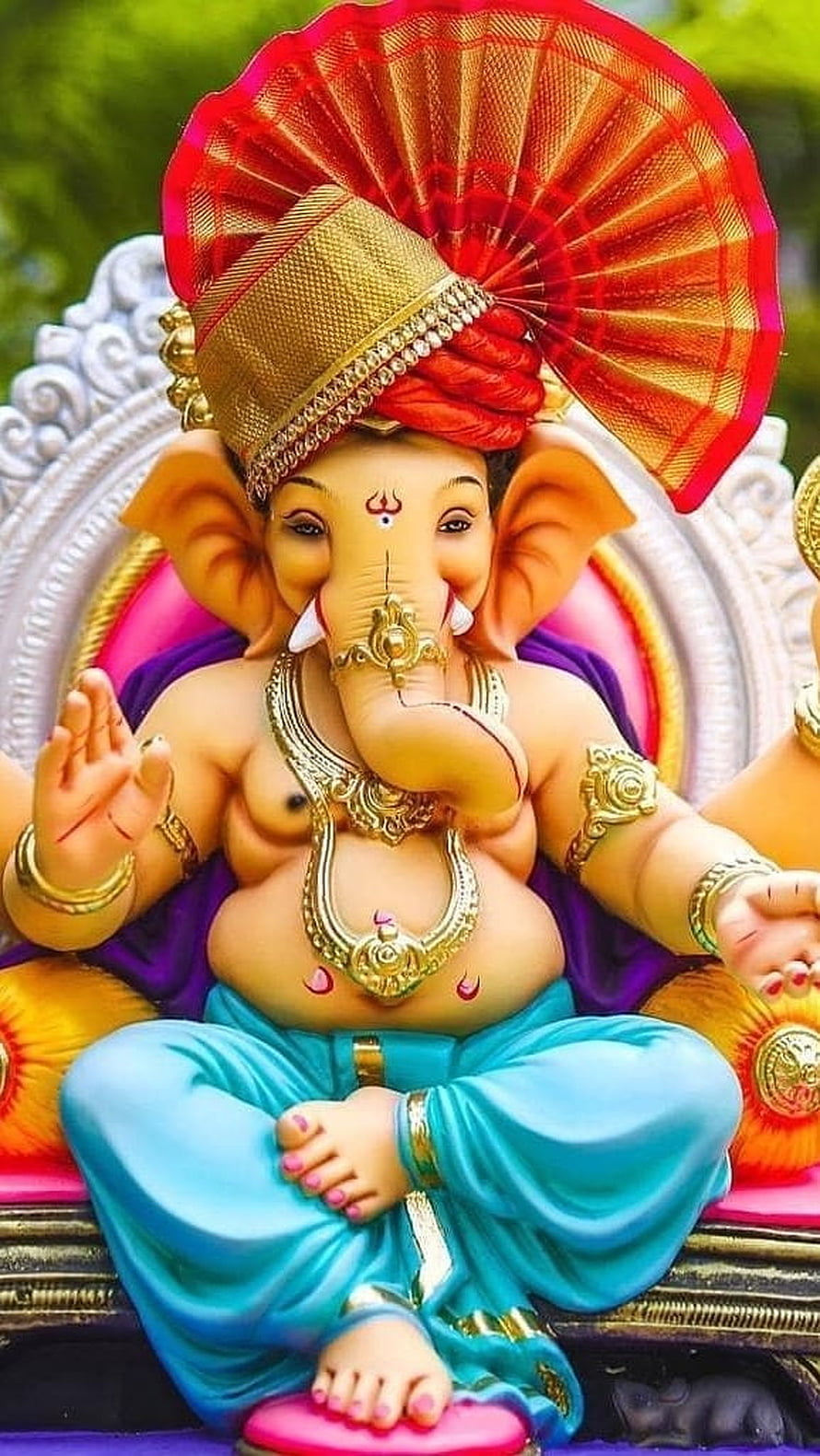 Ganesha Seated Statue With Golden Crown And Red Fan On Ornate Pedestal HD phone wallpaper