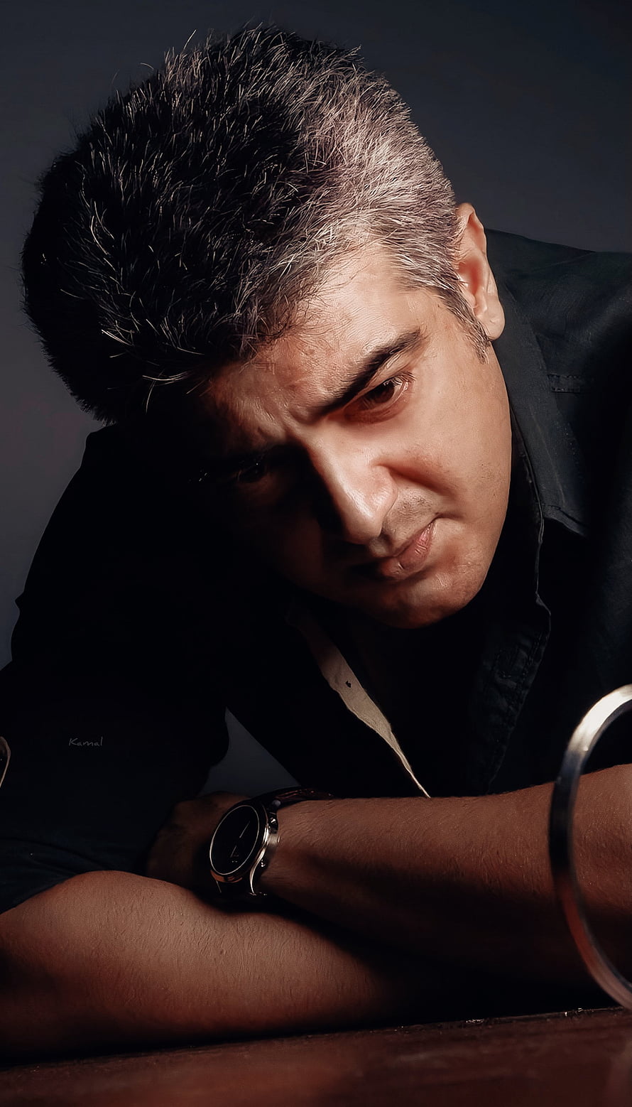 Ajith Kumar moody portrait with dramatic low-key lighting and dark shirt HD phone wallpaper