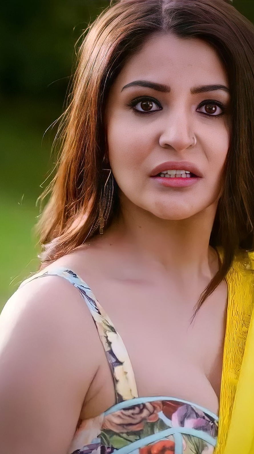 Anushka Sharma in a floral top with yellow dupatta, close-up portrait with soft natural lighting and blurred green background HD phone wallpaper