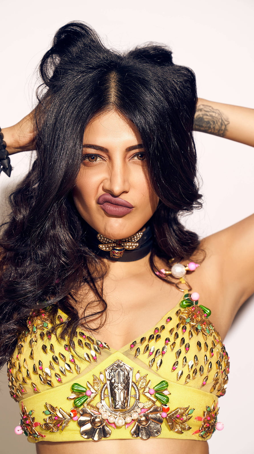 Shruti Hassan in ornate yellow embellished crop top with playful expression and voluminous dark hair HD phone wallpaper