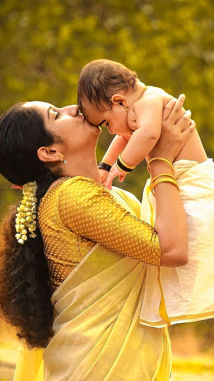 Mother in Yellow Saree Holding Baby in Tender Embrace HD phone wallpaper