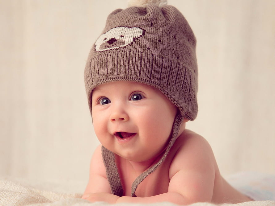 Smiling Baby Boy Wearing Knitted Bear Hat on Soft Blanket HD wallpaper