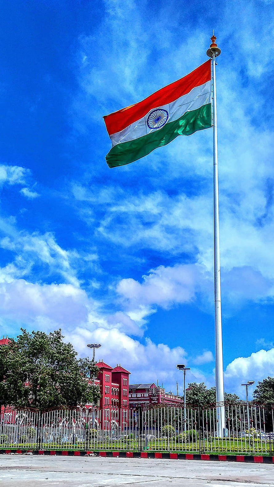 Indian National Flag Flying High Against Blue Sky With Red Colonial Building HD phone wallpaper