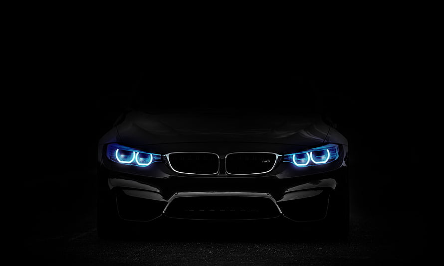 BMW M4 Front View with Glowing Blue Angel Eyes Headlights in Dark Atmosphere HD wallpaper