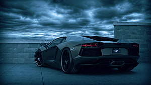 Matte Black Lamborghini Aventador Rear View Under Stormy Blue Sky HD wallpaper