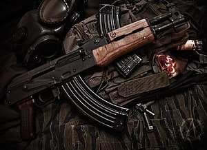AK-47 Assault Rifle with Tactical Gear and Gas Mask on Camouflage Fabric HD wallpaper