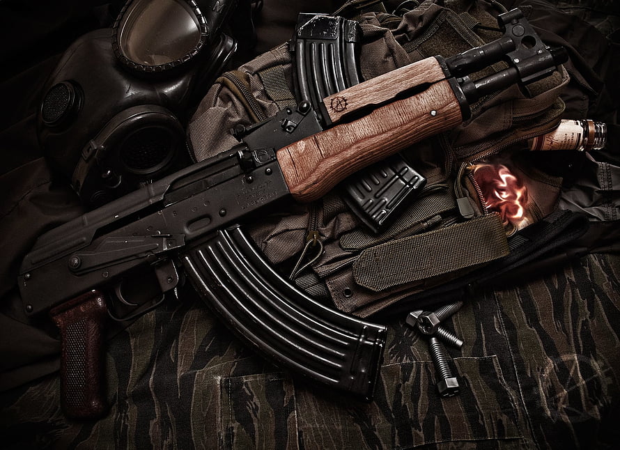 AK-47 Assault Rifle with Tactical Gear and Gas Mask on Camouflage Fabric HD wallpaper