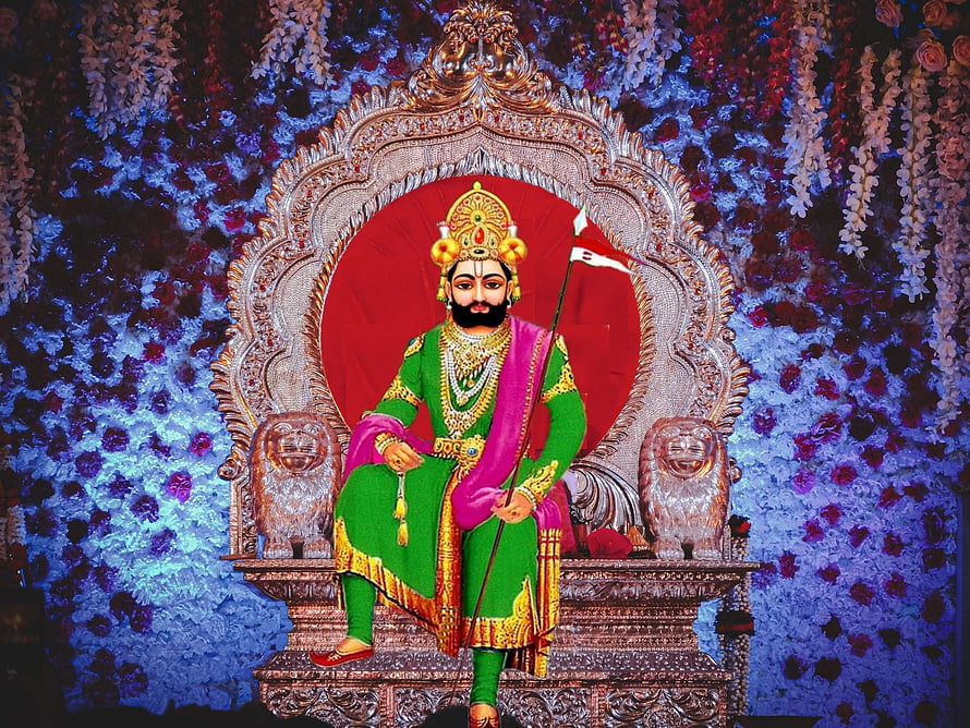 King Prithviraj Chauhan Statue on Ornate Throne with Floral Background HD wallpaper