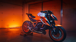Orange KTM RC 390 Motorcycle in Garage with Neon Lighting HD wallpaper