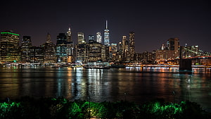 New York City Lower Manhattan Skyline at Night with East River Reflections and Brooklyn Bridge HD wallpaper
