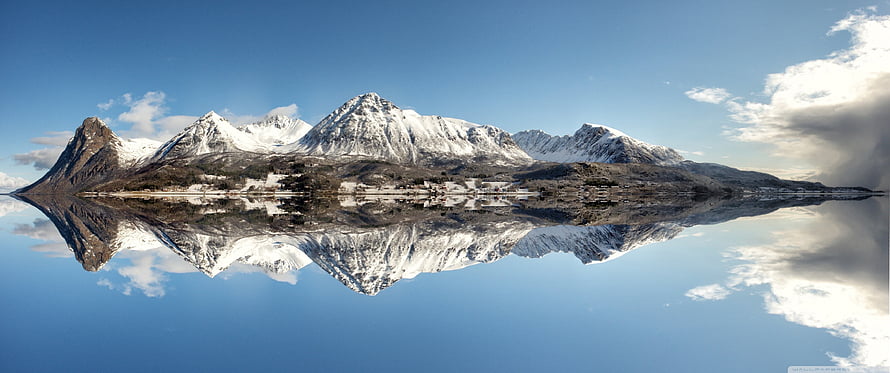 Snow-Capped Mountain Range Reflected in a Calm Alpine Lake Under a Clear Blue Sky HD wallpaper