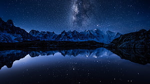 Starry Night Sky Over Snowy Mountains Reflected in Calm Lake HD wallpaper