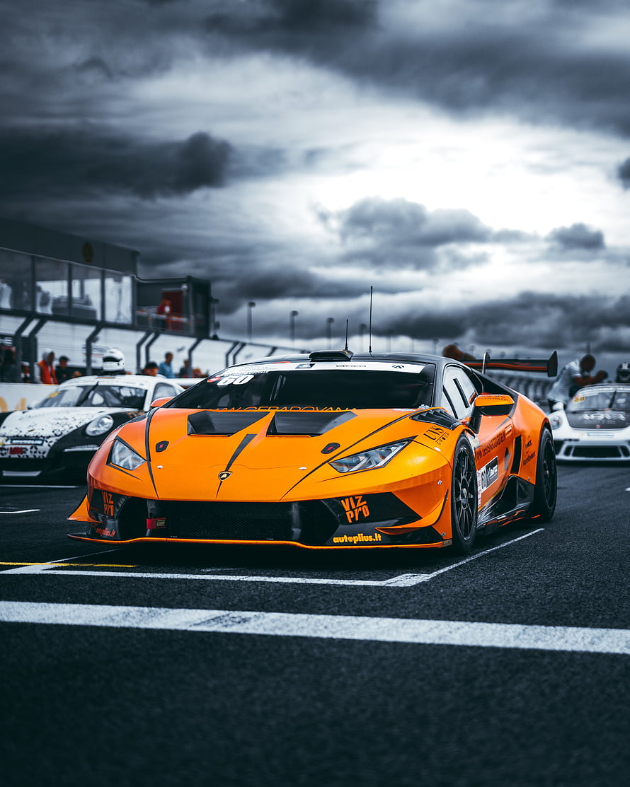 Orange Lamborghini Huracan Super Trofeo race car on track HD phone wallpaper