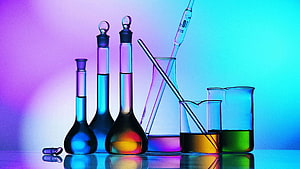 Colorful Chemistry Lab Glassware with Beakers and Flasks on a Neon Gradient Background HD wallpaper