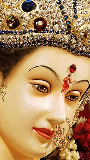 Close-up Portrait of Goddess Lakshmi Statue with Jeweled Crown and Nose Ring HD phone wallpaper