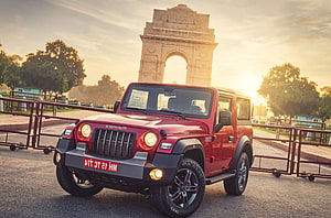 Red Mahindra Thar SUV Parked in Front of India Gate at Sunset HD wallpaper