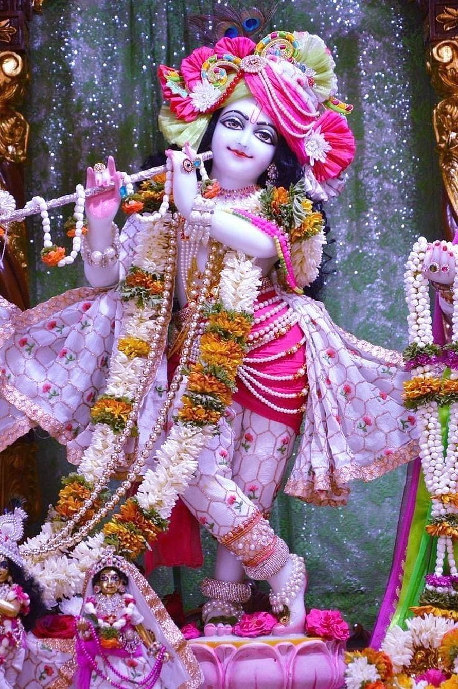 Ornate Krishna Idol Adorned With Floral Garlands And Traditional Jewelry HD phone wallpaper