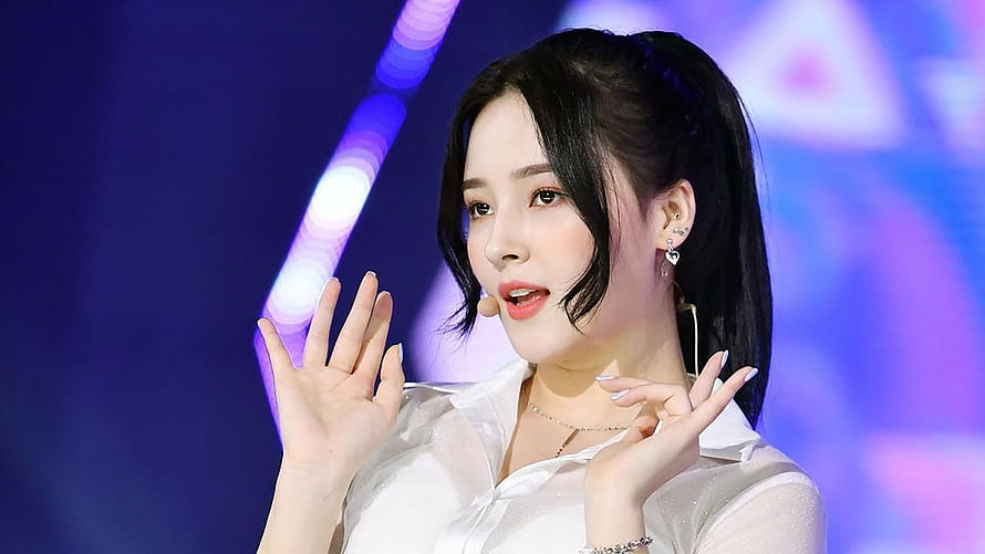 Nancy from Momoland performing on stage in a white outfit with blue background HD wallpaper