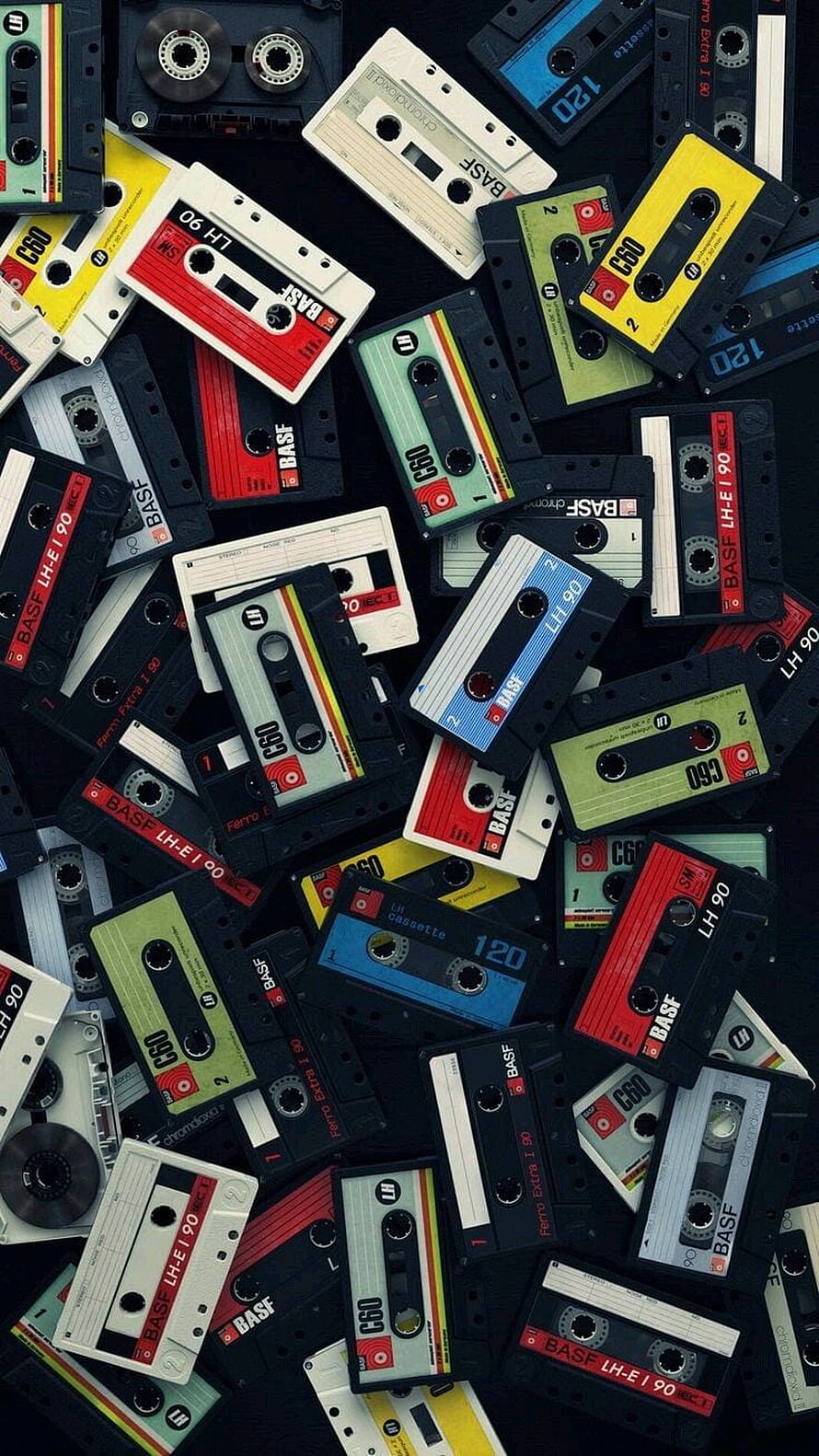 Retro Assortment of Vintage Audio Cassettes on Dark Background HD phone wallpaper