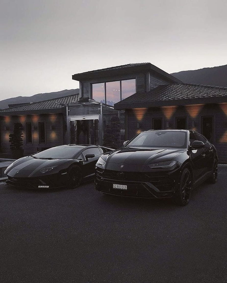 Black Lamborghini Urus and Huracan Parked in Front of Modern Luxury Residence at Dusk HD phone wallpaper