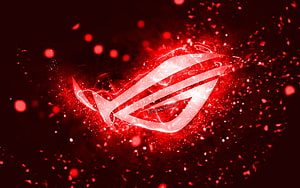 Republic of Gamers ROG Logo with Red Neon Glow and Particle Effects on Dark Background HD wallpaper