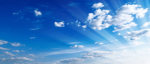 Vast Blue Sky With Fluffy White Clouds And Radiant Sunbeams HD wallpaper