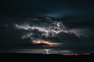 Dramatic Night Thunderstorm with Lightning Strike Over Dark Horizon HD wallpaper