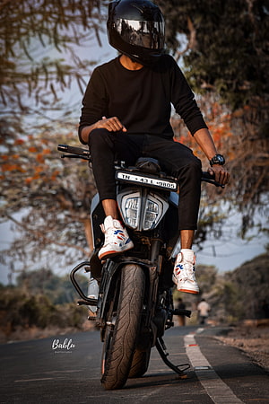 Rider on a KTM motorcycle on a scenic road at golden hour HD phone wallpaper