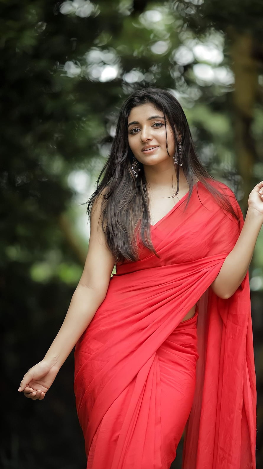 Mirna Ravi in a vibrant red saree with elegant drape and long dark hair HD phone wallpaper