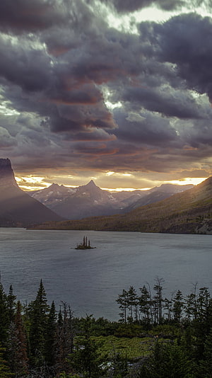 St Mary Lake at Dusk in Glacier National Park with Dramatic Clouds and Mountain Peaks HD phone wallpaper