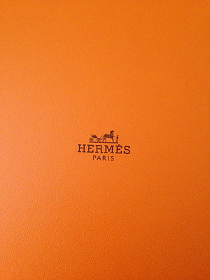 Hermes Paris Logo on Signature Orange Leather Texture Minimalist Design HD phone wallpaper