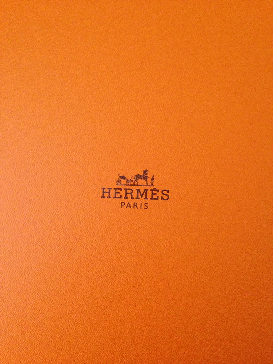 Hermes Paris Logo on Signature Orange Leather Texture Minimalist Design HD phone wallpaper