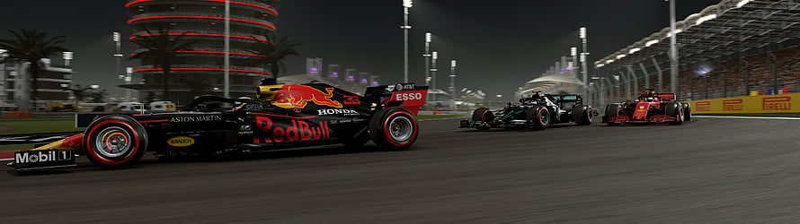 Red Bull Racing Formula 1 car leading a night race at the Yas Marina Circuit with Ferrari and Mercedes competitors HD wallpaper