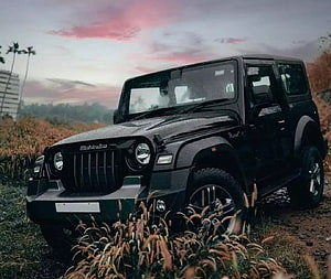 Black Mahindra Thar SUV parked in a grassy field at sunset HD wallpaper