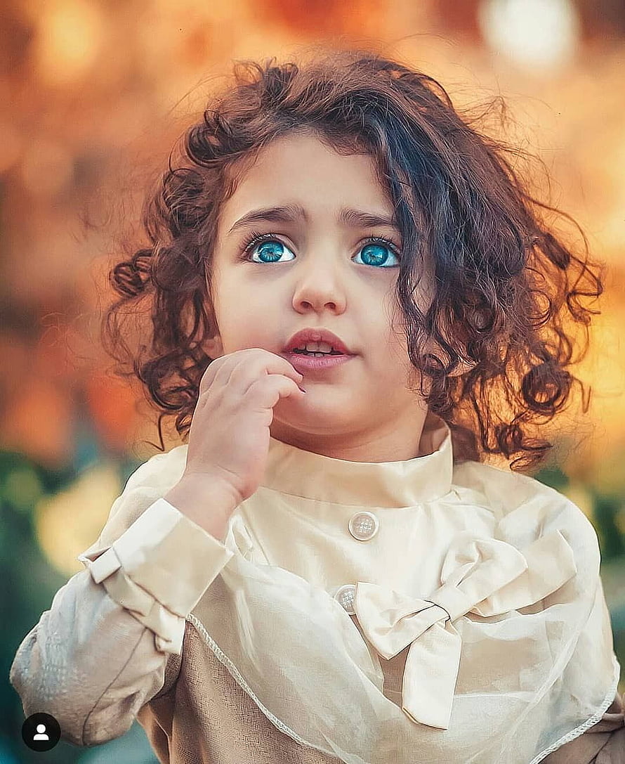 Portrait of a Toddler Girl with Curly Hair and Blue Eyes Wearing a Cream Bow Blouse HD phone wallpaper