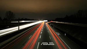 Asus branded highway at night with red and white light trails HD wallpaper