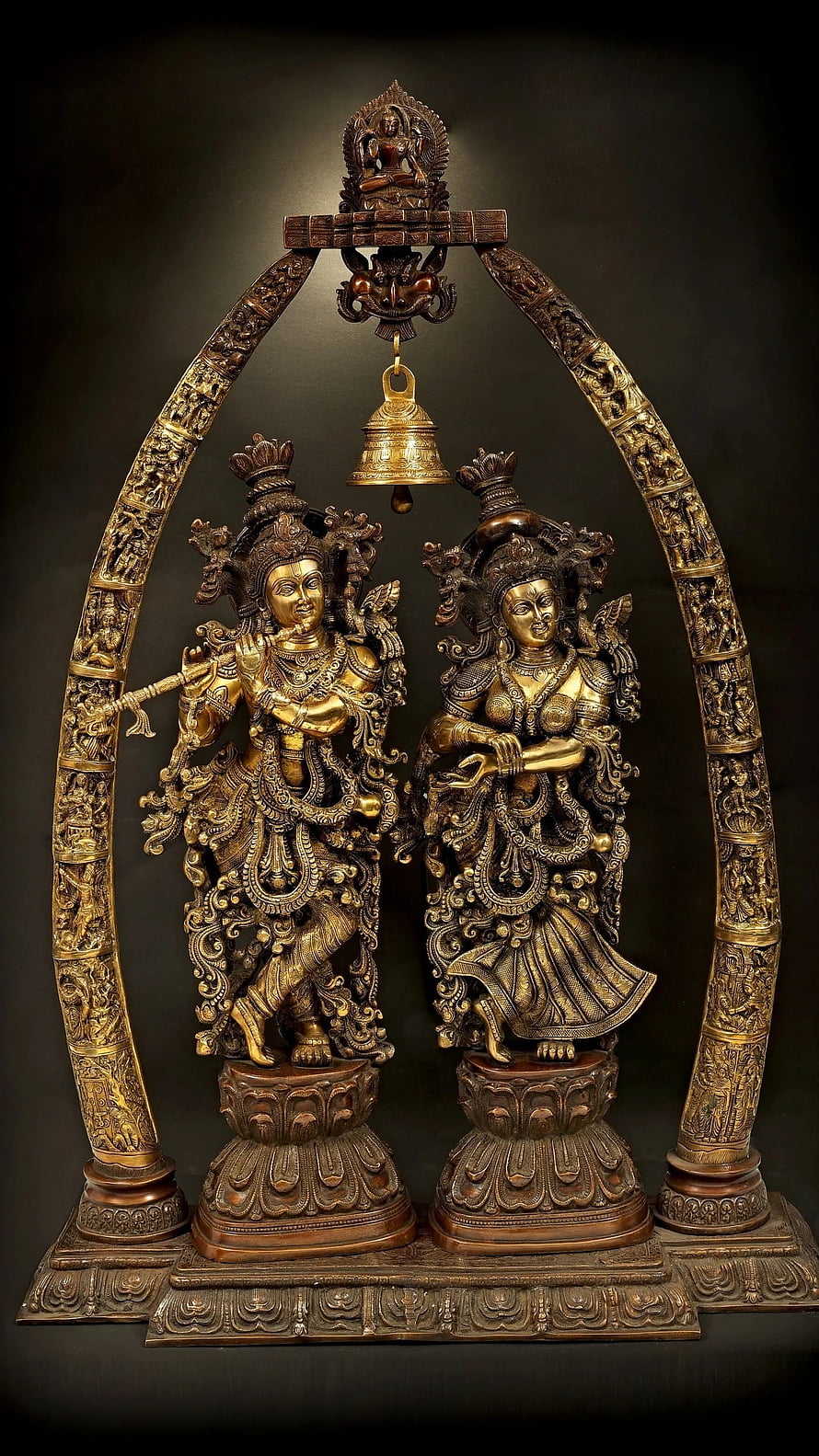 Ornate Bronze Radha Krishna Temple Arch with Hanging Bell and Intricate Carvings HD phone wallpaper