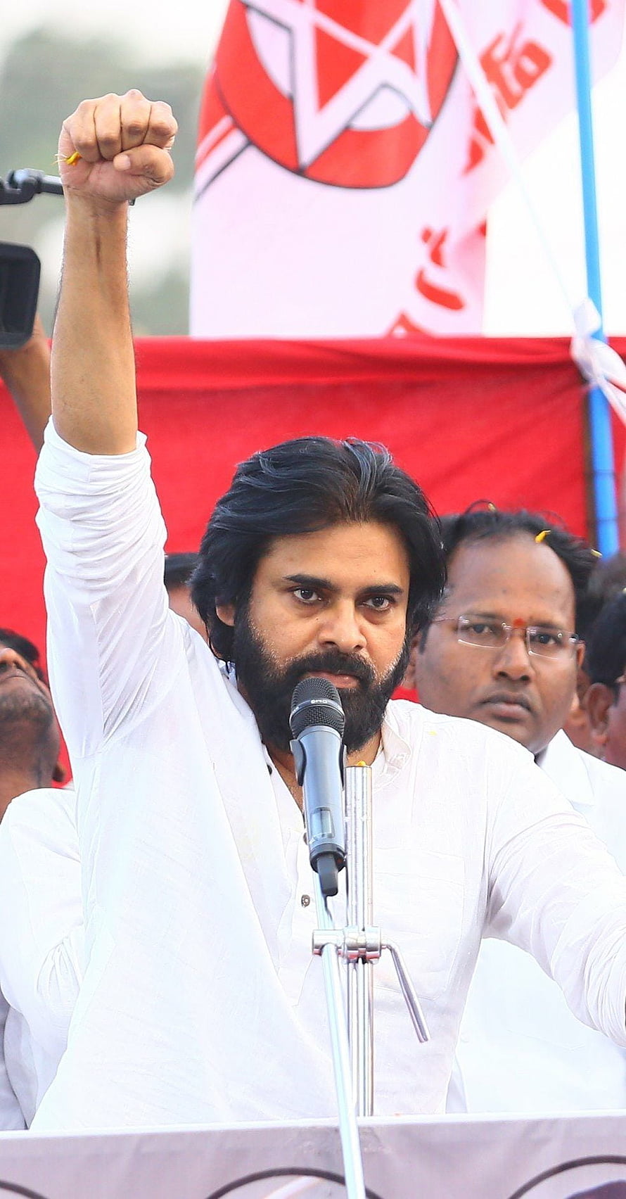 Pawan Kalyan raising fist at political rally wearing white kurta HD phone wallpaper