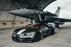 Matte Black Bugatti Chiron Super Sport 300+ Parked Under Military Jet in Hangar HD wallpaper