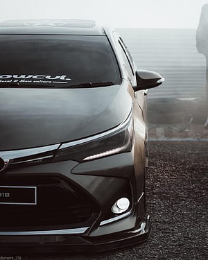 Black Toyota Corolla Front Fascia Close-Up with LED Headlights and Sporty Bumper HD phone wallpaper