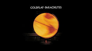 Coldplay Parachutes Album Artwork Featuring Glowing Orange Globe on Dark Background HD wallpaper