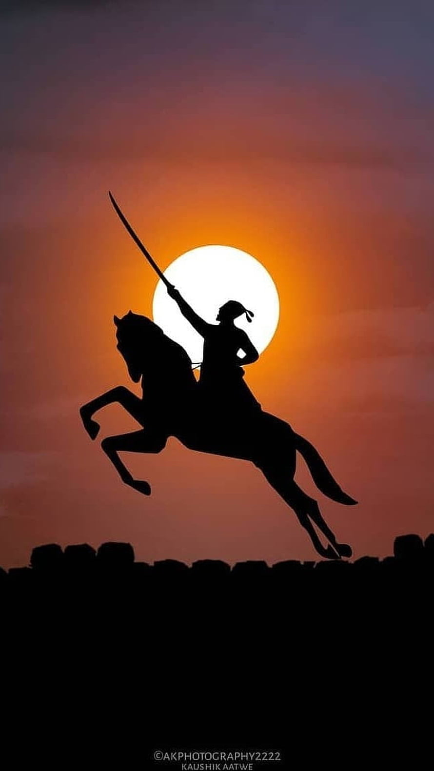 Silhouette of a Warrior on Horseback with Sword Raised Against Sunset HD phone wallpaper
