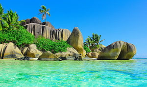 Tropical Beach with Giant Granite Boulders and Turquoise Water HD wallpaper