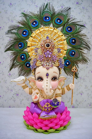 Baby Ganesha Figurine with Peacock Crown and Lotus Base HD phone wallpaper