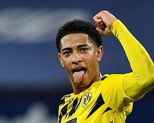 Jude Bellingham in Borussia Dortmund Yellow Kit Flexing and Sticking Out Tongue HD wallpaper