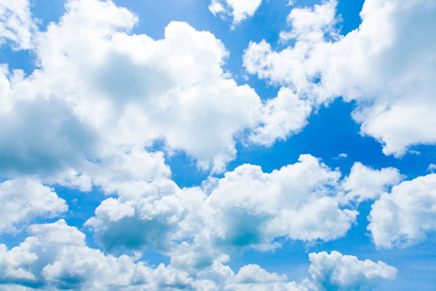 Fluffy White Cumulus Clouds Drifting Across a Bright Blue Summer Sky HD wallpaper
