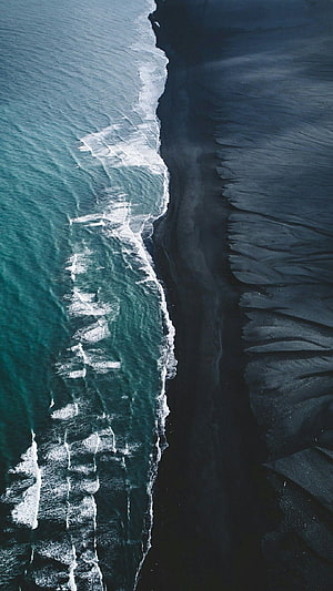 Aerial View of Black Sand Beach in Iceland with Turquoise Waves and Dark Dunes HD phone wallpaper