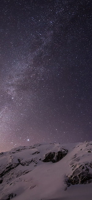 Milky Way Galaxy Arching Over Snow-Covered Mountain Ridge at Night HD phone wallpaper