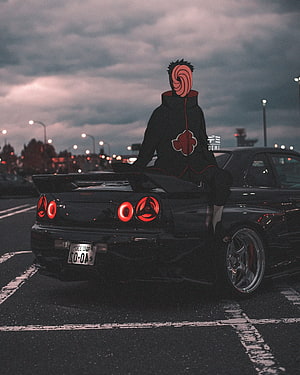 Pain from Naruto sitting on a black Nissan Skyline GT-R R34 in a dark urban street scene HD phone wallpaper